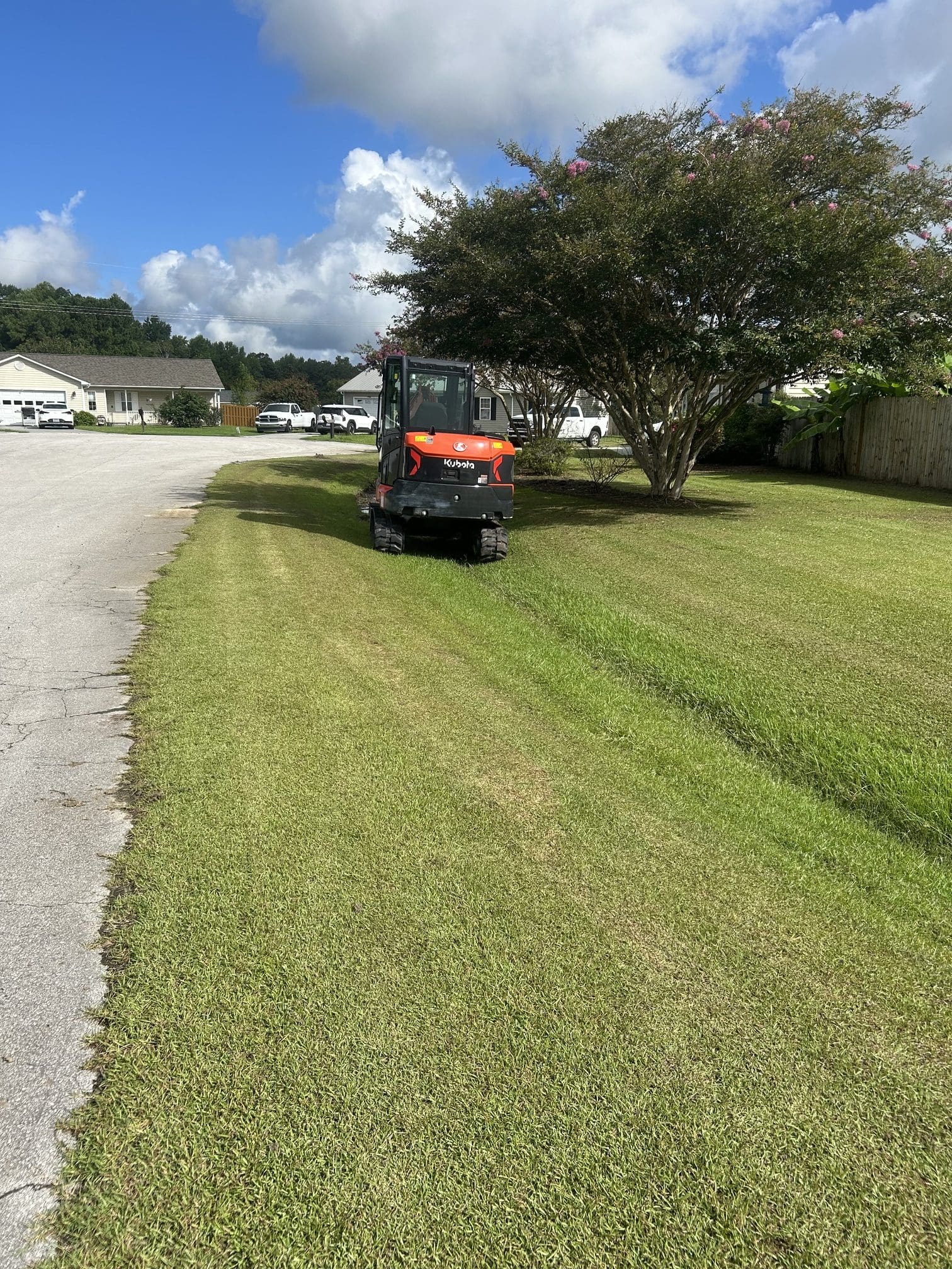 Cleared and regraded drainage ditch running to a driveway culvert